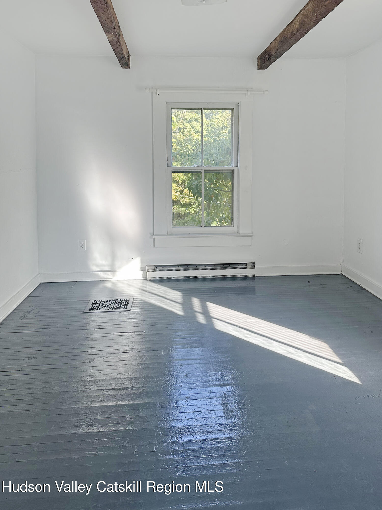 72 Meads Mountain Road, Unit 5 Woodstock, NY 12498 - Photo 12 of 20 an empty room with wooden floor and windows