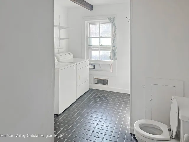 a bathroom with a sink toilet and window