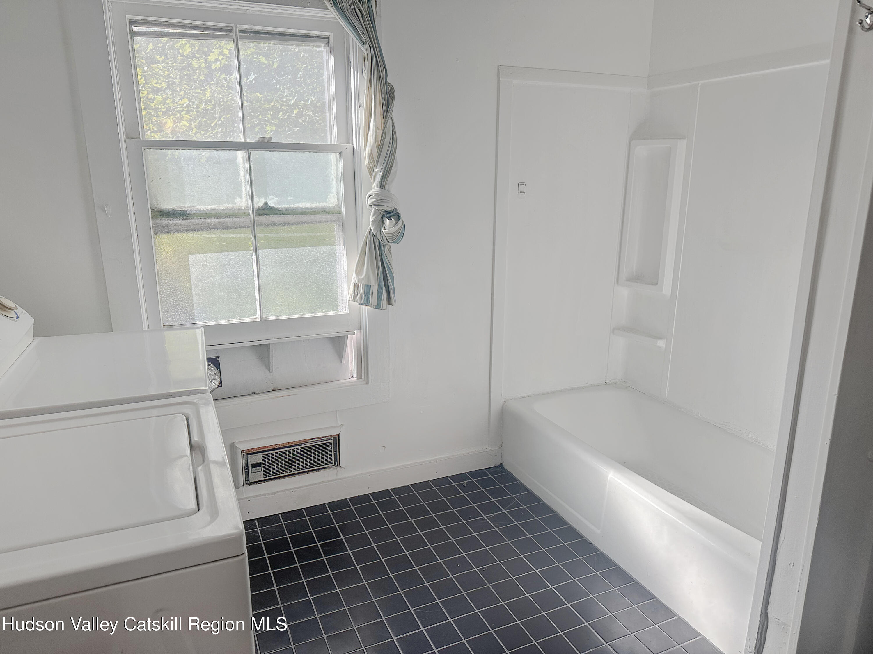 72 Meads Mountain Road, Unit 5 Woodstock, NY 12498 - Photo 15 of 20 a bathroom with a bathtub and a window