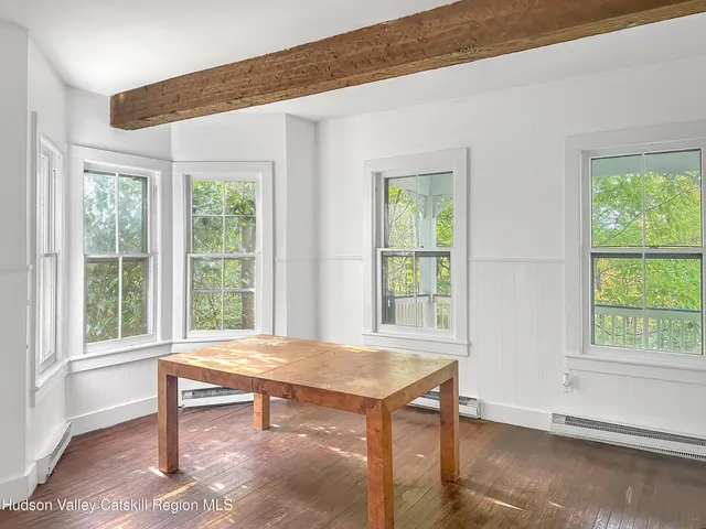 a view of a room with furniture and windows