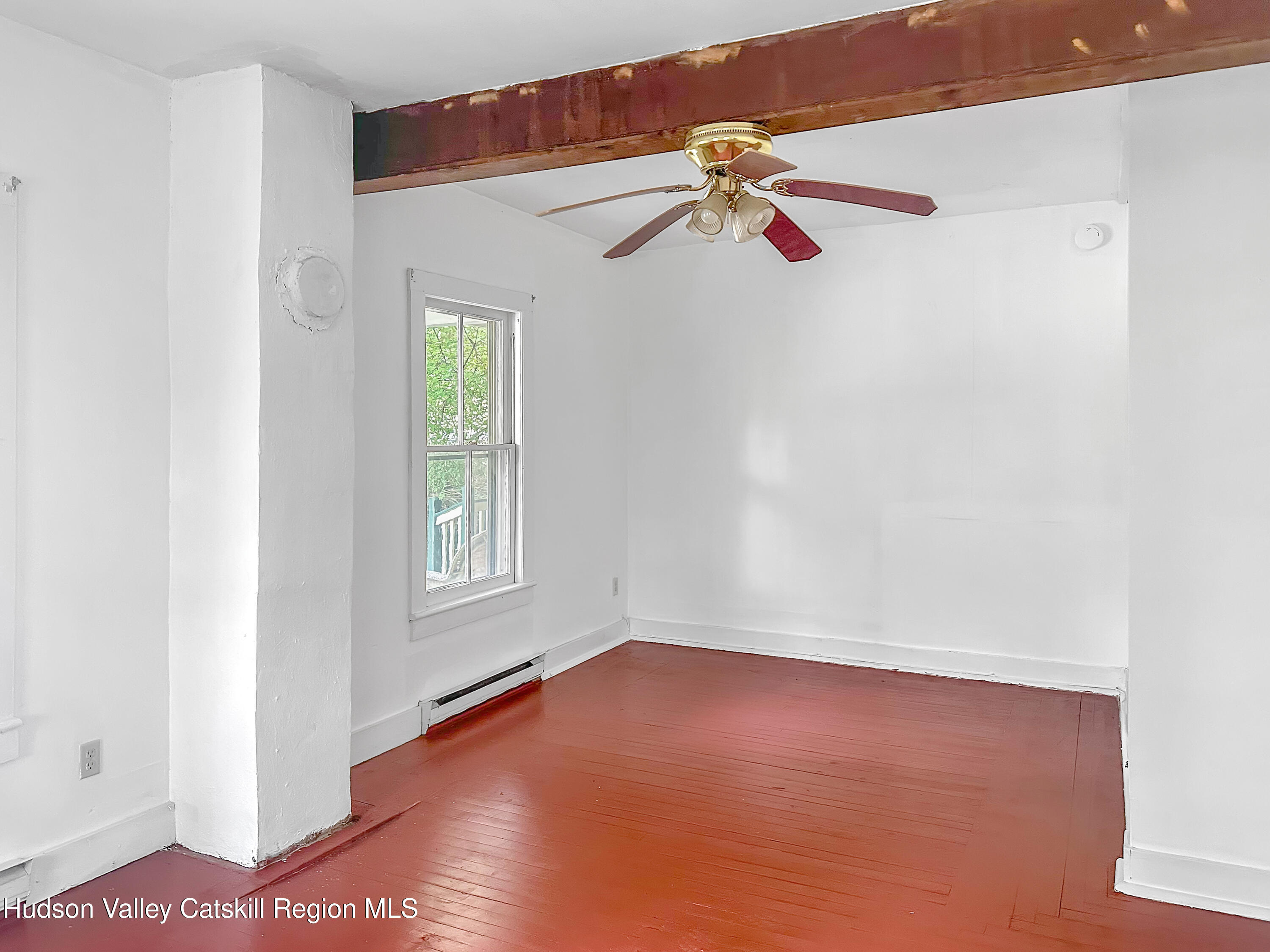 72 Meads Mountain Road, Unit 5 Woodstock, NY 12498 - Photo 9 of 20 a view of an empty room with wooden floor and a window