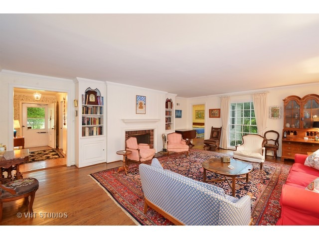 220 Dickens Road Northfield, IL 60093 - Photo 5 of 17 a living room with furniture a fireplace and a table