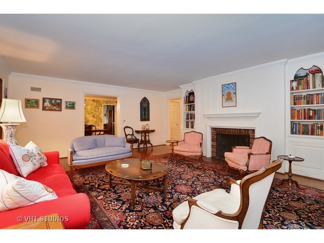220 Dickens Road Northfield, IL 60093 - Photo 7 of 17 a living room with furniture a fireplace and a table