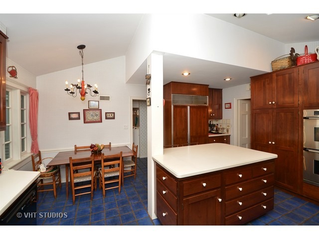 220 Dickens Road Northfield, IL 60093 - Photo 10 of 17 a living room with furniture a dining table and a refrigerator