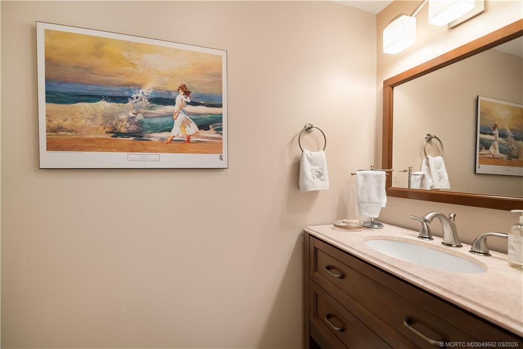 853 Northwest Spruce Ridge Drive Stuart, FL 34994 - Photo 17 of 20 a bathroom with a granite countertop sink and a mirror