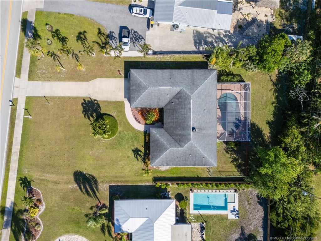 853 Northwest Spruce Ridge Drive Stuart, FL 34994 - Photo 5 of 20 an aerial view of a house with a swimming pool