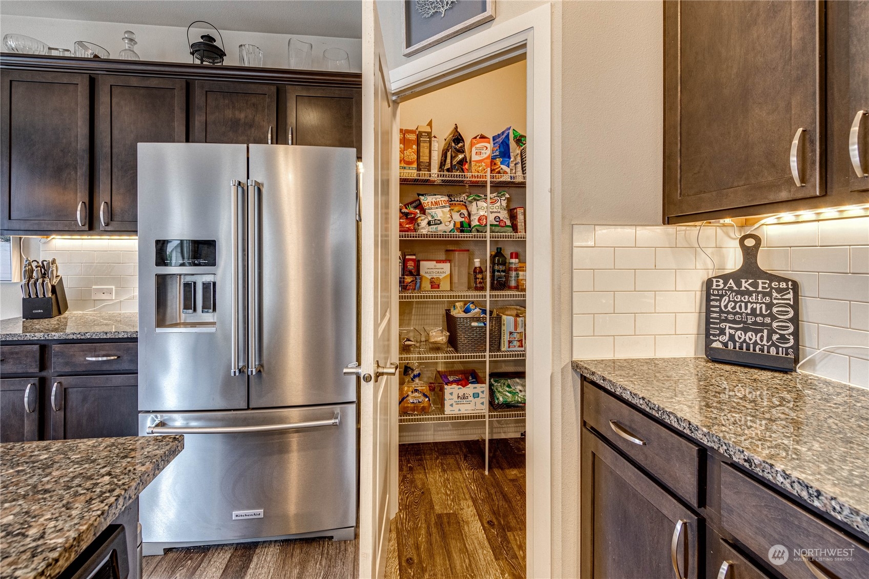 222 202nd Street Southeast Bothell, WA 98012 - Photo 12 of 37 a kitchen with granite countertop a refrigerator and a stove top oven