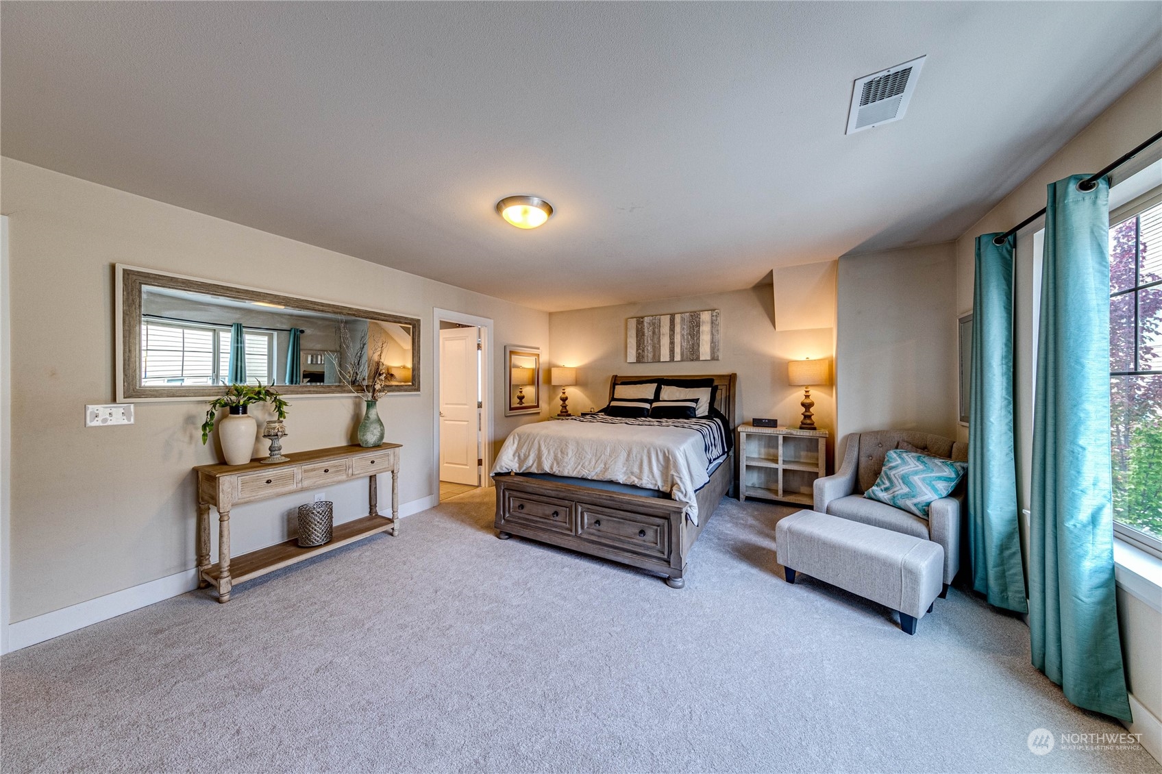 222 202nd Street Southeast Bothell, WA 98012 - Photo 21 of 37 a spacious bedroom with a bed a couch and large windows