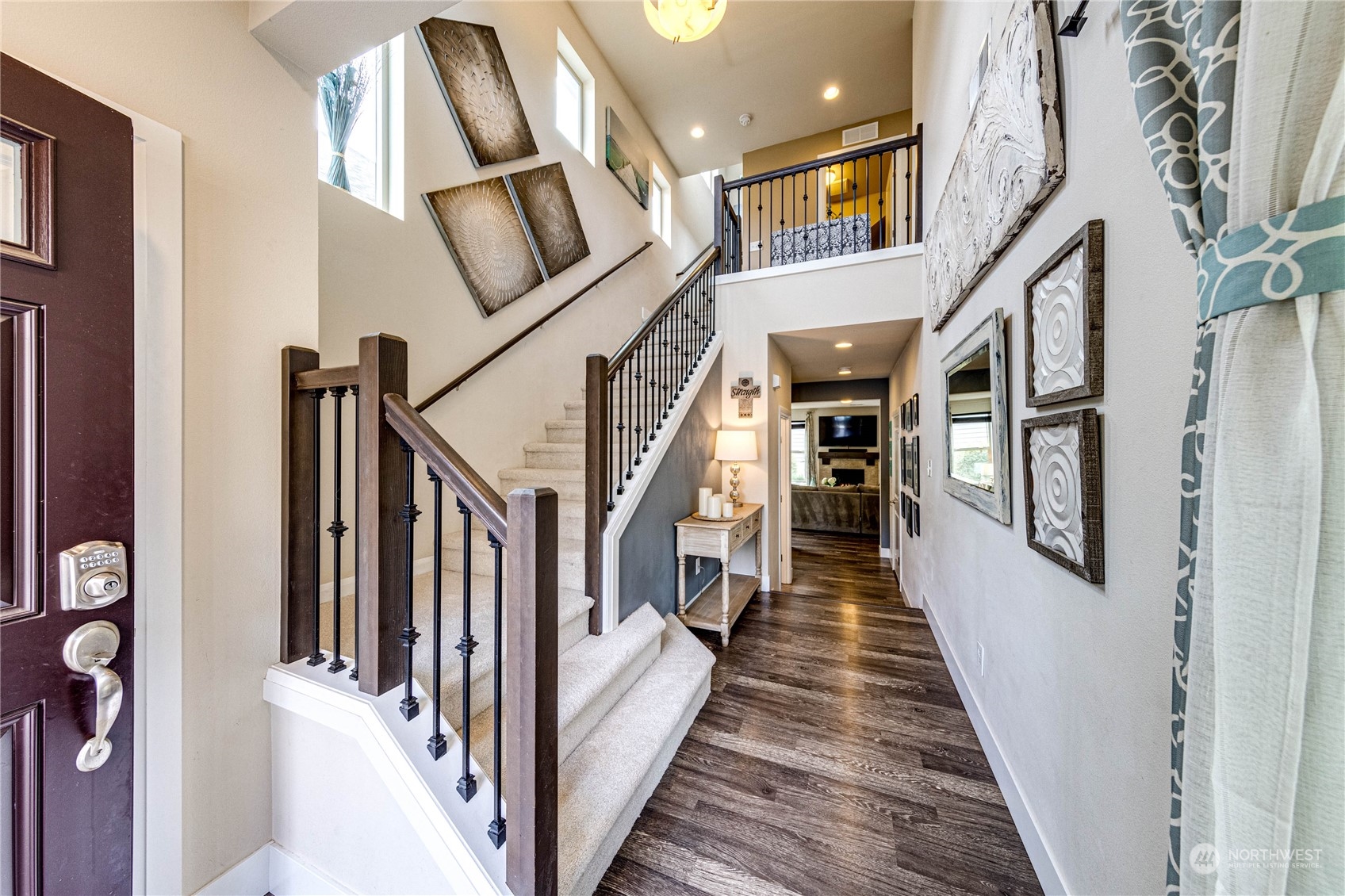 222 202nd Street Southeast Bothell, WA 98012 - Photo 4 of 37 a view of staircase with lots of frames on wall and a window