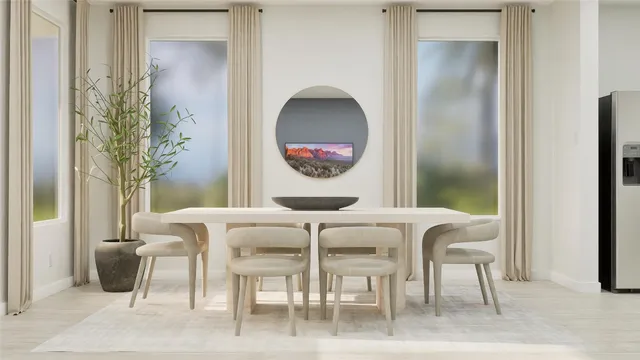 a view of a dining room with furniture and a potted plant
