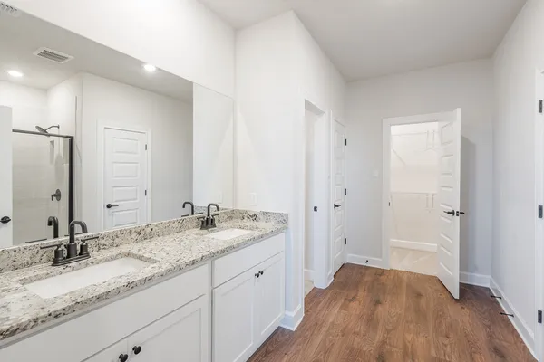 a bathroom with a glass shower door