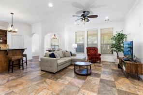 1155 Whipporwill Road Conroe, TX 77303 - Photo 16 of 34 a living room with furniture and a flat screen tv