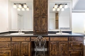 1155 Whipporwill Road Conroe, TX 77303 - Photo 22 of 34 a bathroom with a sink and a mirror