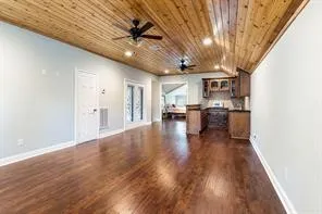 a view of a livingroom with wooden floor and a large window