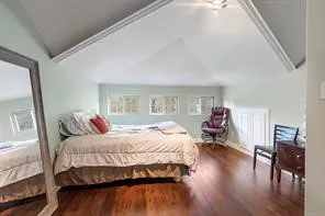 a bedroom with a bed and a tv on the dresser