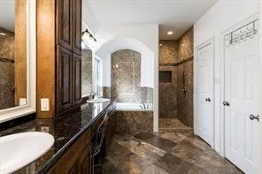 a bathroom with a bathtub and a shower