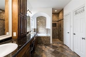 1155 Whipporwill Road Conroe, TX 77303 - Photo 31 of 34 a bathroom with double vanity and a bathtub