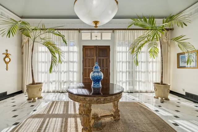 a living room with furniture a rug and a window