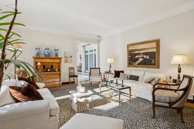 a living room filled with furniture and a floor to ceiling window