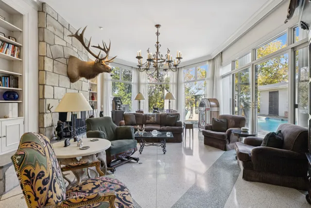 a living room with furniture fireplace and a large window