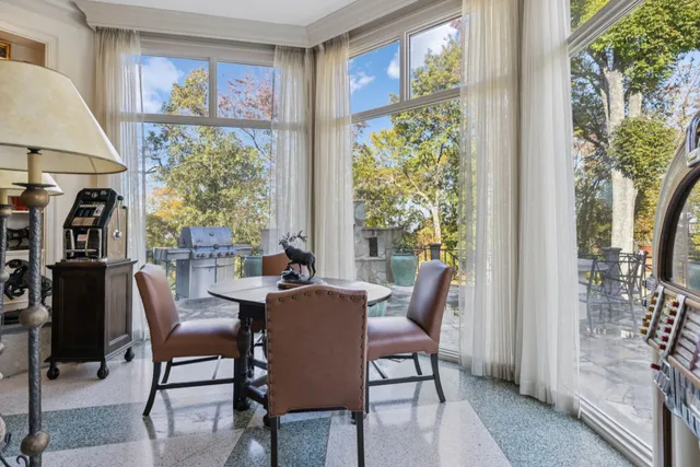 a bedroom with furniture and a large window