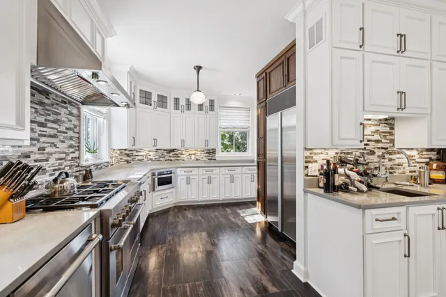 a spacious bathroom with a double vanity sink a mirror and a shower
