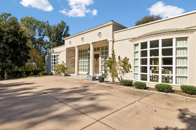 a view of a hallway with furniture and a chandelier