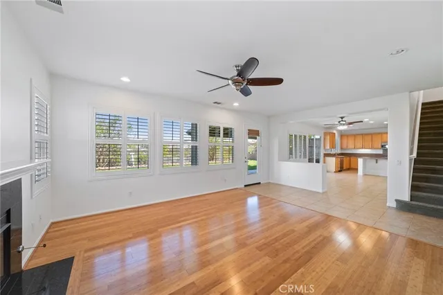 a view of an empty room with a fireplace and a window