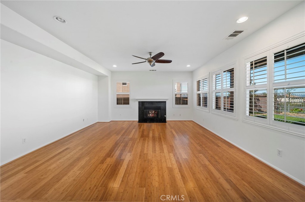 33710 Sattui Street Temecula, CA 92592 - Photo 19 of 75 a view of empty room with wooden floor and fireplace