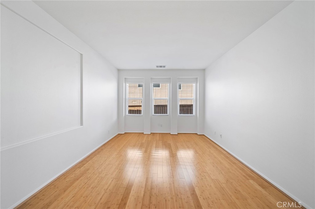 33710 Sattui Street Temecula, CA 92592 - Photo 30 of 75 a view of an empty room with wooden floor and a window