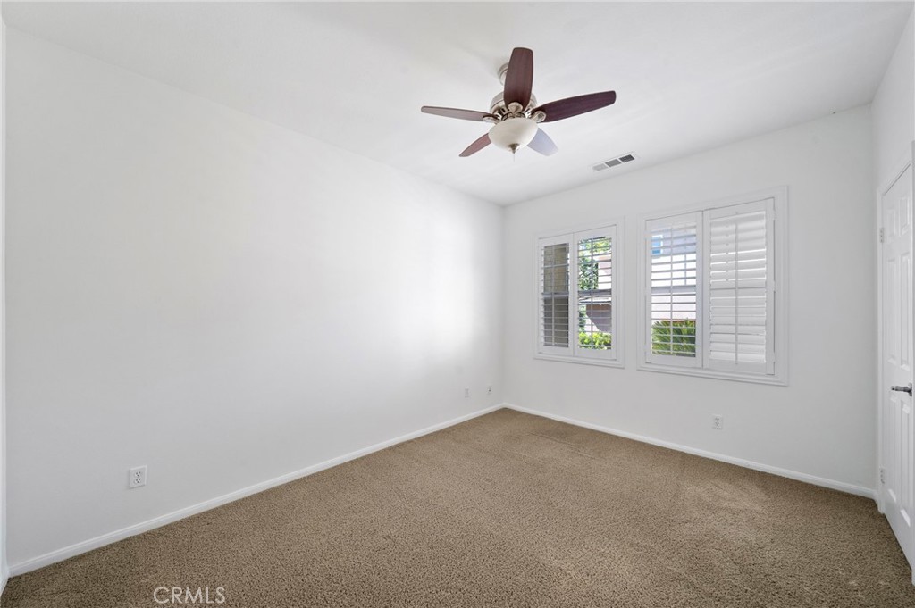 33710 Sattui Street Temecula, CA 92592 - Photo 38 of 75 a view of a big room with windows and chandelier fan