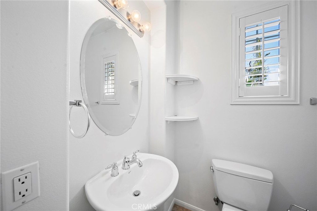33710 Sattui Street Temecula, CA 92592 - Photo 43 of 75 a bathroom with a sink a toilet and a mirror