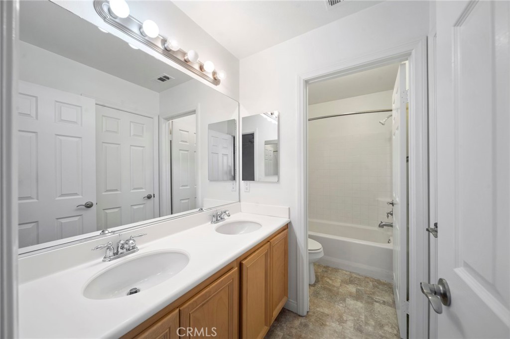33710 Sattui Street Temecula, CA 92592 - Photo 53 of 75 a bathroom with a double vanity sink mirror and shower