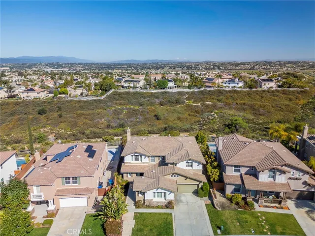 a kitchen with kitchen island granite countertop a refrigerator a sink a stove a dining table and chairs