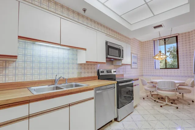 a kitchen with a sink appliances and cabinets