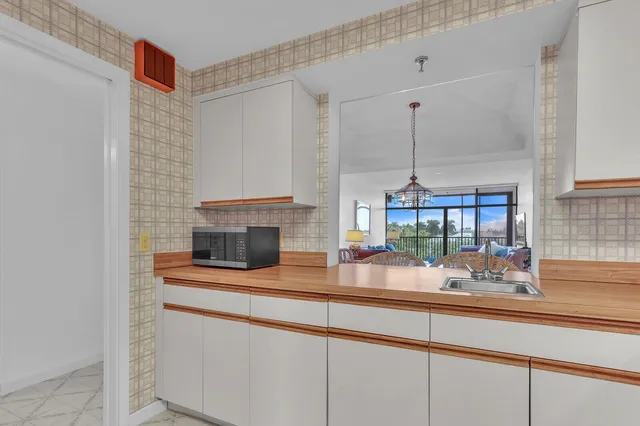 a kitchen with a sink and a wooden floor