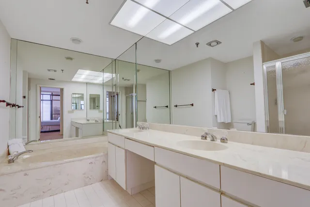 a spacious bathroom with a sink double vanity and a large mirror
