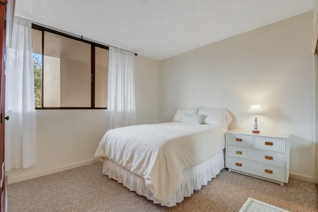 a bedroom with a bed and a night stand