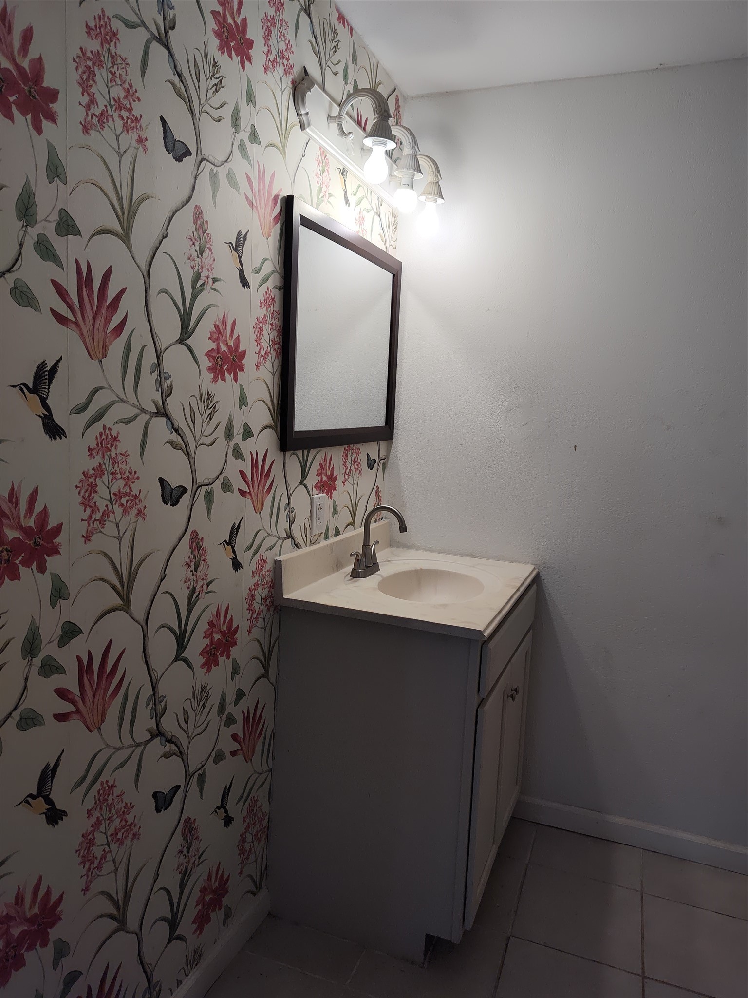 527 West 6th Street Freeport, TX 77541 - Photo 15 of 25 a bathroom with a sink and mirror with vanity