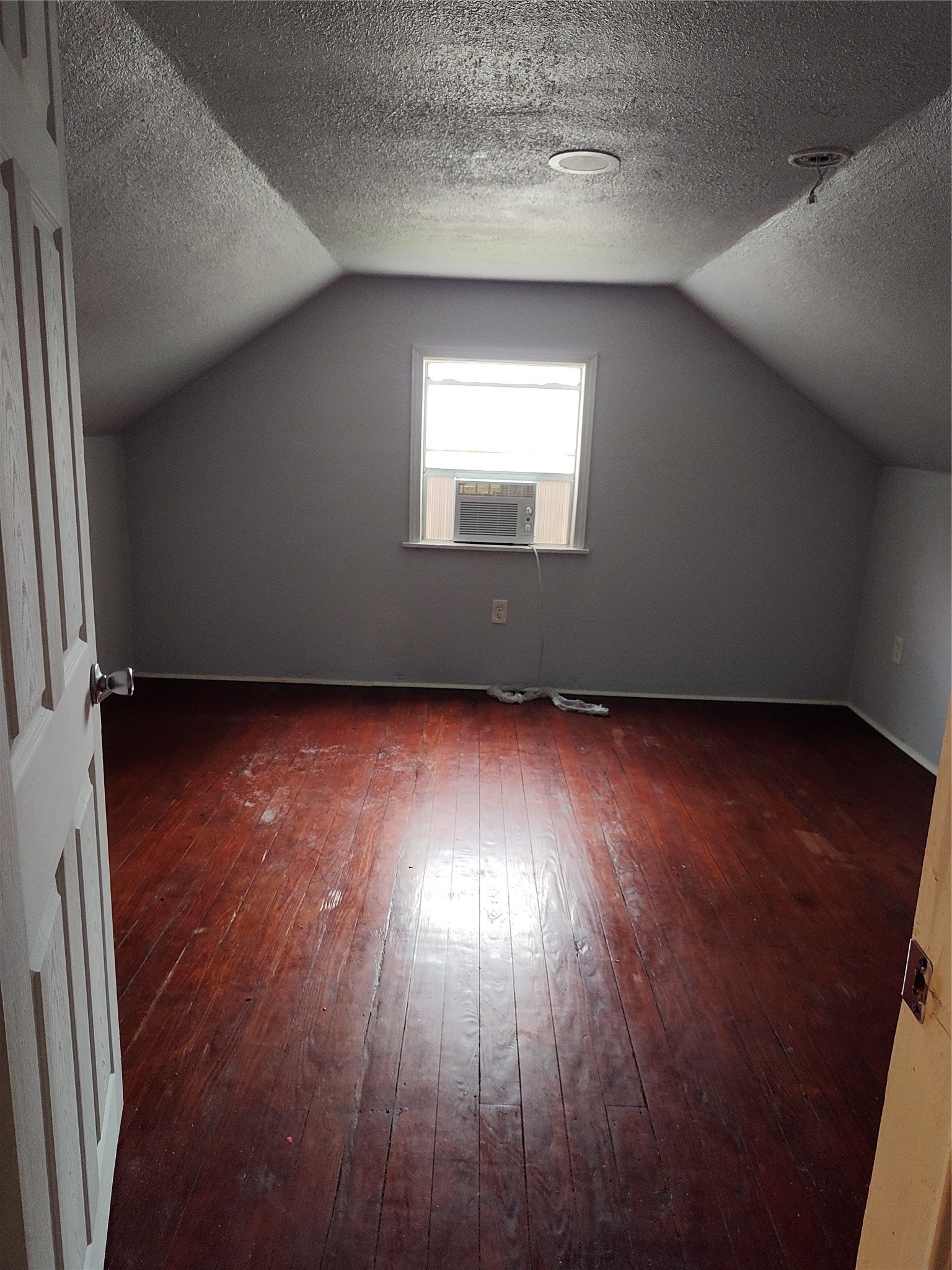 527 West 6th Street Freeport, TX 77541 - Photo 18 of 25 an empty room with wooden floor and windows