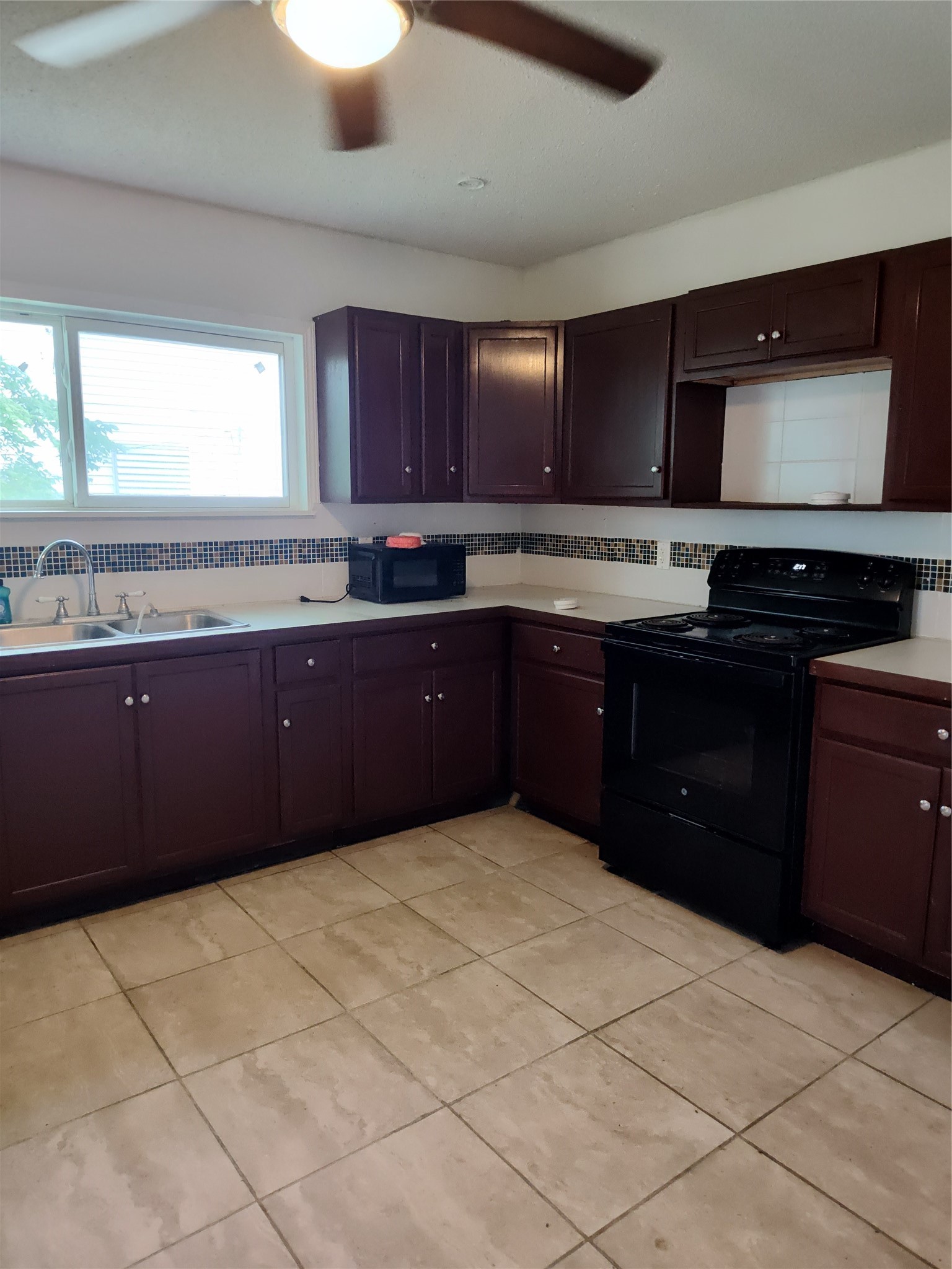 527 West 6th Street Freeport, TX 77541 - Photo 6 of 25 a kitchen with stainless steel appliances granite countertop a sink and cabinets