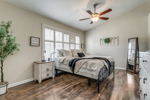 a bedroom with a bed and a ceiling fan