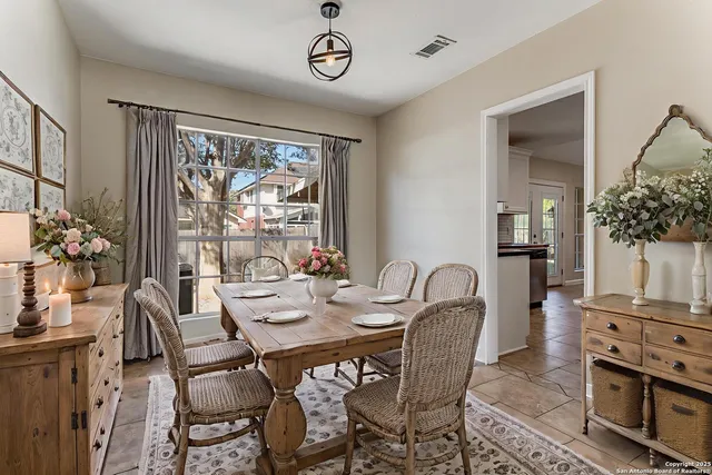 a dining room with furniture a flat screen tv and a large window