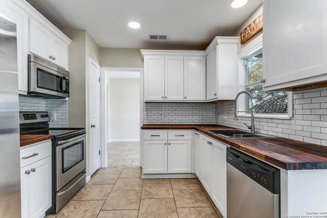a kitchen with a sink stove and microwave