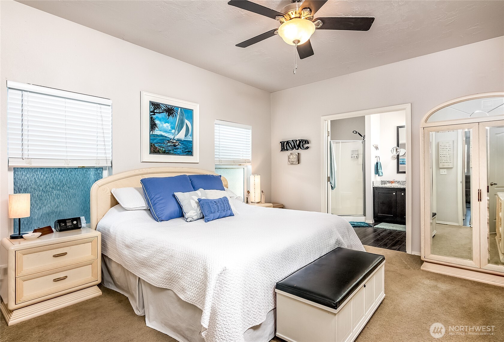 2101 South 324th Street, Unit 53 Federal Way, WA 98003 - Photo 16 of 38 a bedroom with a large bed and a chandelier