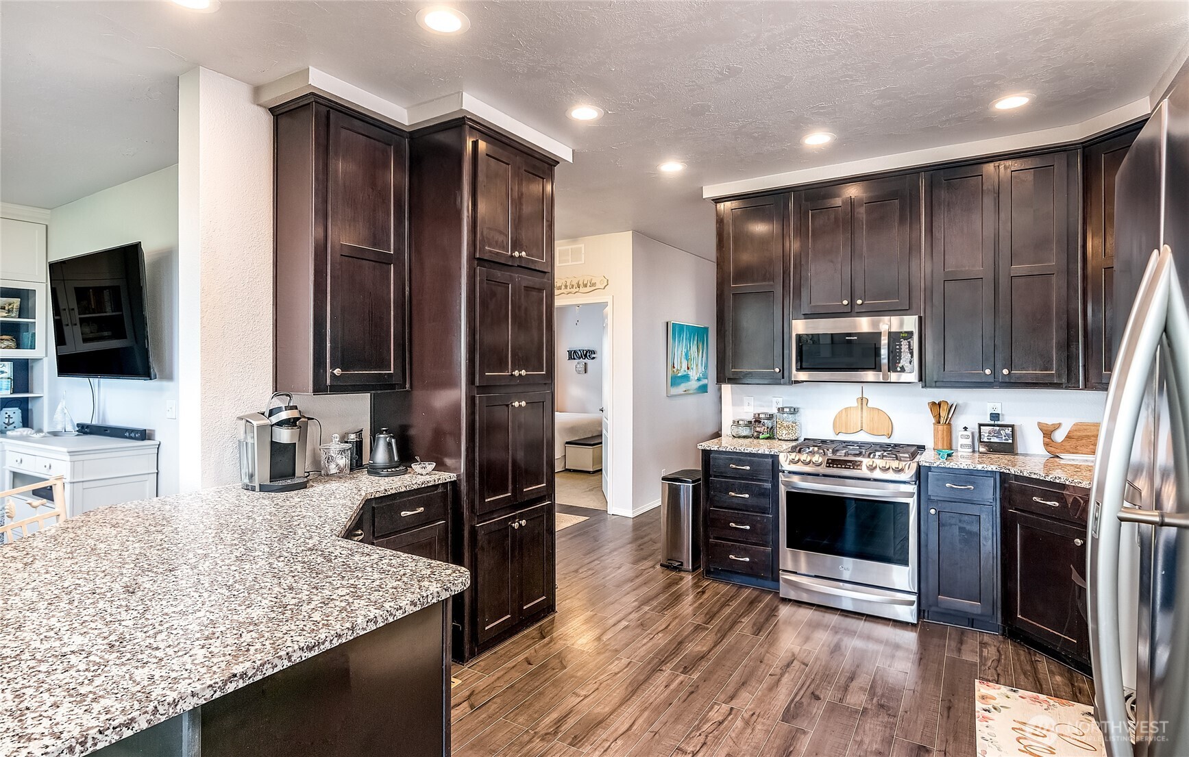 2101 South 324th Street, Unit 53 Federal Way, WA 98003 - Photo 6 of 38 a kitchen with stainless steel appliances granite countertop a stove refrigerator sink and stove