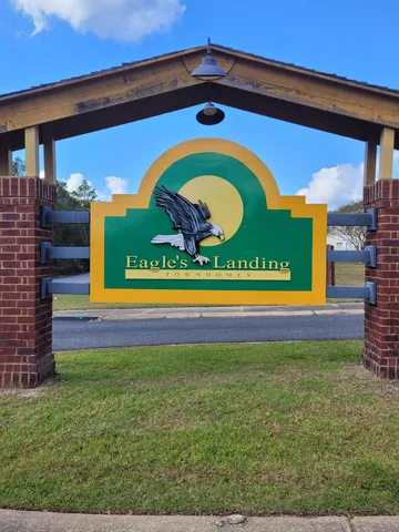 a view of a park with a bench and trees