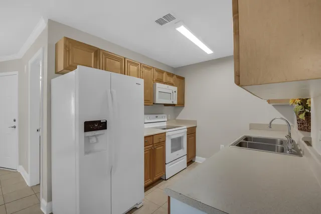 a white refrigerator freezer sitting inside of a kitchen