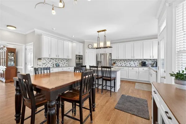 a view of a dining room with furniture and wooden floor