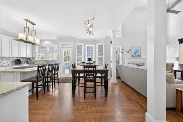 a view of a dining room with furniture window and wooden floor